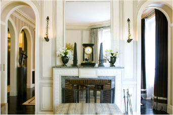 The symmetrical doorways on either side of the marble fireplace are amazing.