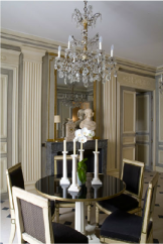 Classic chandelier, French moldings, and a black and gold dining table and chairs. Perfect!